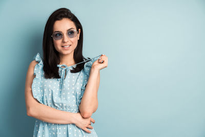 Portrait of a smiling young woman against white background