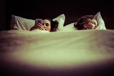 Two women lying in bed