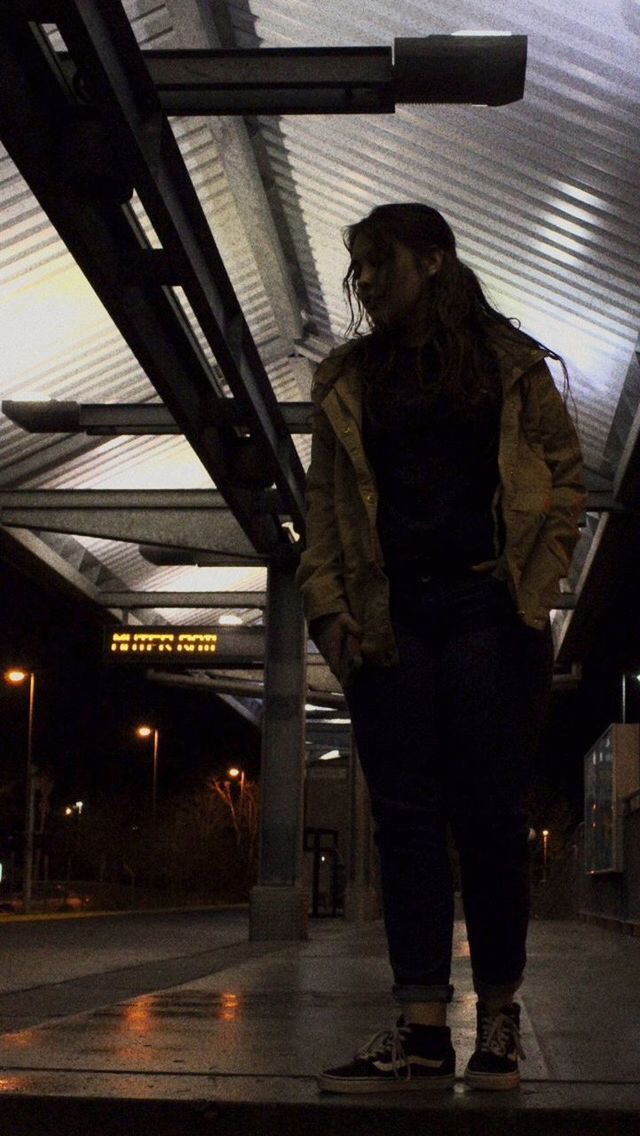 FULL LENGTH OF MAN STANDING IN ILLUMINATED UNDERGROUND