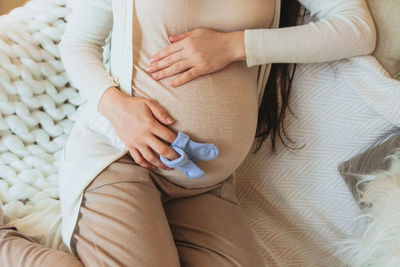 Midsection of doctor examining patient at home