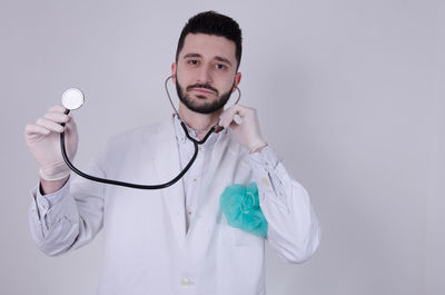 Portrait of young man holding white background