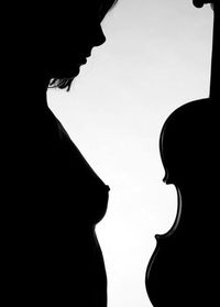 Close-up of silhouette couple against white background