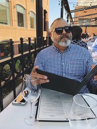 Portrait of man sitting on table