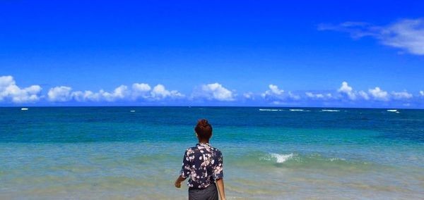 Rear view of man standing on beach