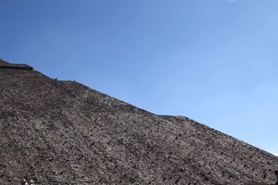 Low angle view of mountain against clear blue sky