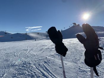 Rear view of people on snowcapped mountain against sky