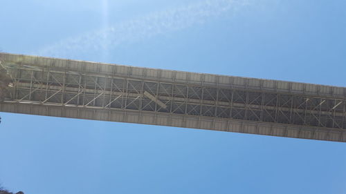 Low angle view of bridge against blue sky