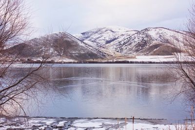 Scenic view of frozen lake against sky during winter