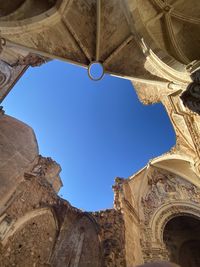 Low angle view of historical building against clear blue sky