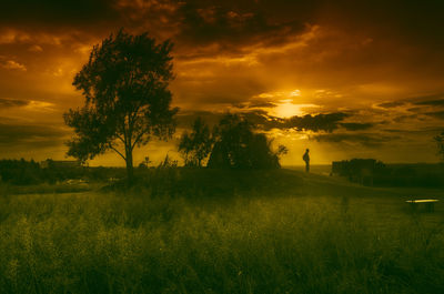 Scenic view of field against cloudy sky