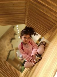 Portrait of girl smiling while sitting at home