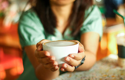 Close-up of woman holding coffee cup