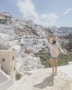 Rear view of woman standing against sky