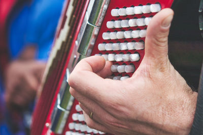 Close-up of man playing piano