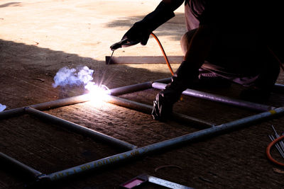 Midsection of man working with fire hydrant
