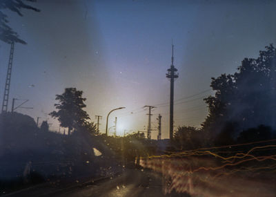 Street amidst buildings against sky at dusk