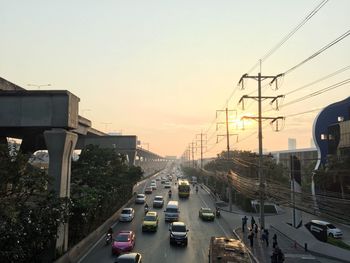 Traffic on road in city against sky