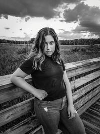 Portrait of woman on field against sky