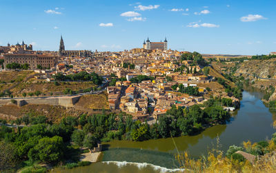 Aerial view of river amidst buildings in city