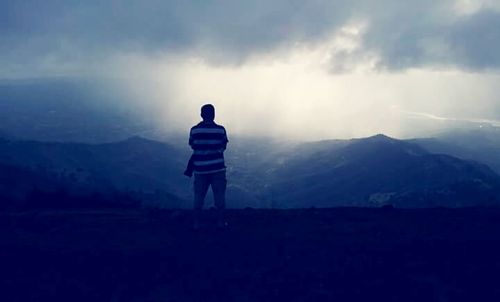 Scenic view of mountains against cloudy sky