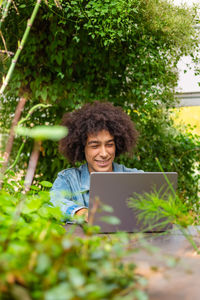 Young woman using laptop at park