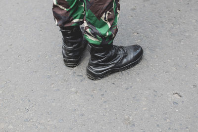 Low section of person wearing shoes standing outdoors
