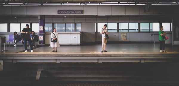 People standing in corridor of building