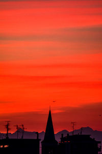 Silhouette buildings against sky during sunset