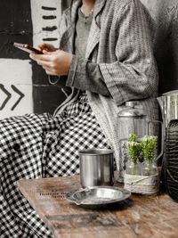 Midsection of man using laptop on table