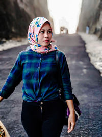 Portrait of a beautiful young woman standing outdoors