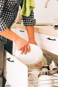 Rear view of woman washing hands in bathroom