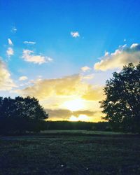 Scenic view of field against sky during sunset