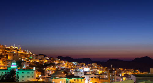 High angle shot of illuminated townscape against sky at night