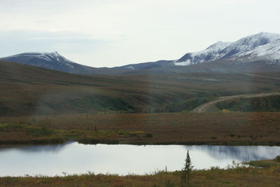 Scenic view of lake and mountains against sky