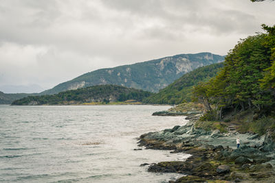 Scenic view of sea and mountains against sky