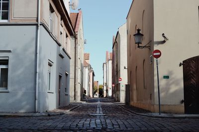 Narrow street amidst buildings in city