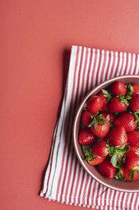 High angle view of strawberries in bowl on table