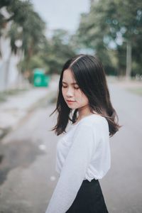 Portrait of beautiful young woman standing outdoors