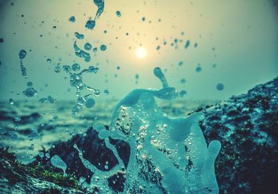 Close-up of water drops on glass of sea