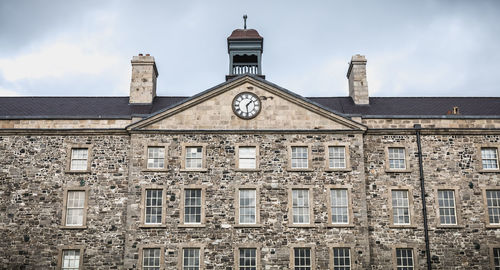 Low angle view of clock tower against sky