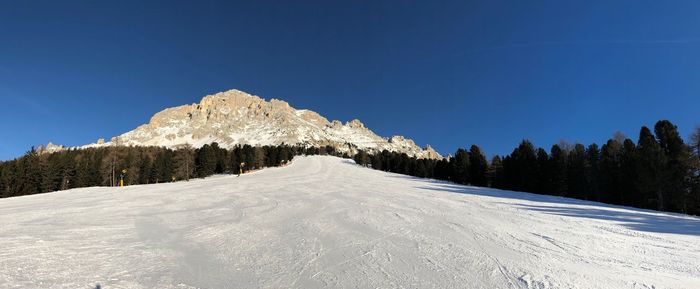 Snow covered mountain against blue sky