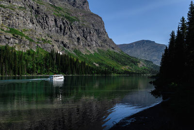 Scenic view of lake by mountains against sky