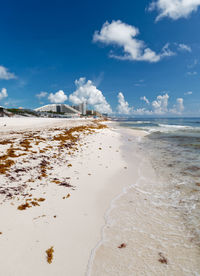 Scenic view of beach against blue sky