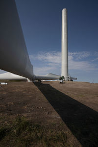 Wind turbines on field against clear blue sky during sunny day at south dakota