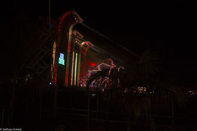 Illuminated ferris wheel at night