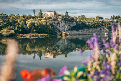 Scenic view of lake against cloudy sky