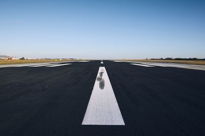 Airport runway against clear sky