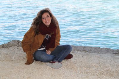 Portrait of a smiling young woman sitting outdoors