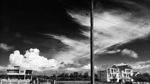 Low angle view of building against cloudy sky