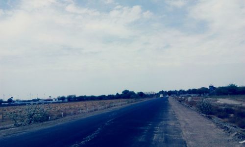Road passing through field